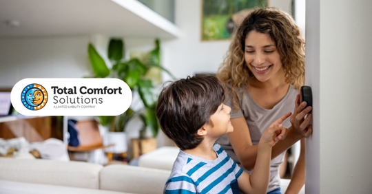 Photo of woman and child adjusting thermostat