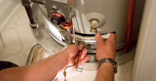 Man troubleshooting a water heater